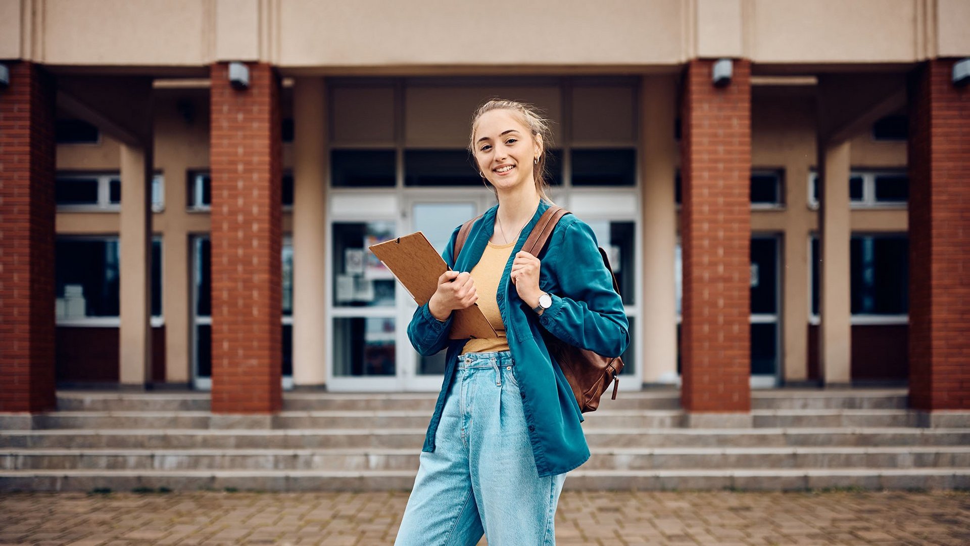 a decorative element: young woman against the background of a building